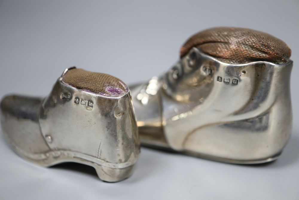 Two early 20th century novelty silver mounted pin cushions, modelled as shoes,